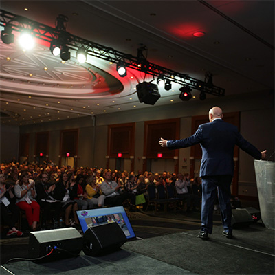 Will Bowen addressing a large conference audience
