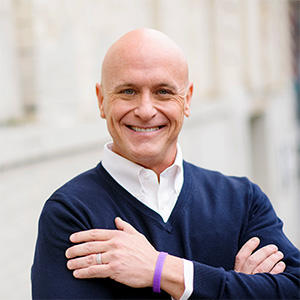 Will Bowen smiling with his arms crossed