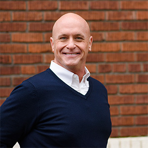 Will Bowen smiling in front of a brick wall