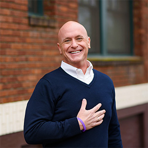 Will Bowen smiling with his hand over his heart