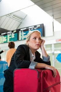 business woman waiting for her departure at the airport symboli